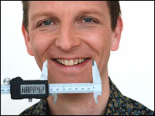 BBC journalist Mark Easton having his smile measured